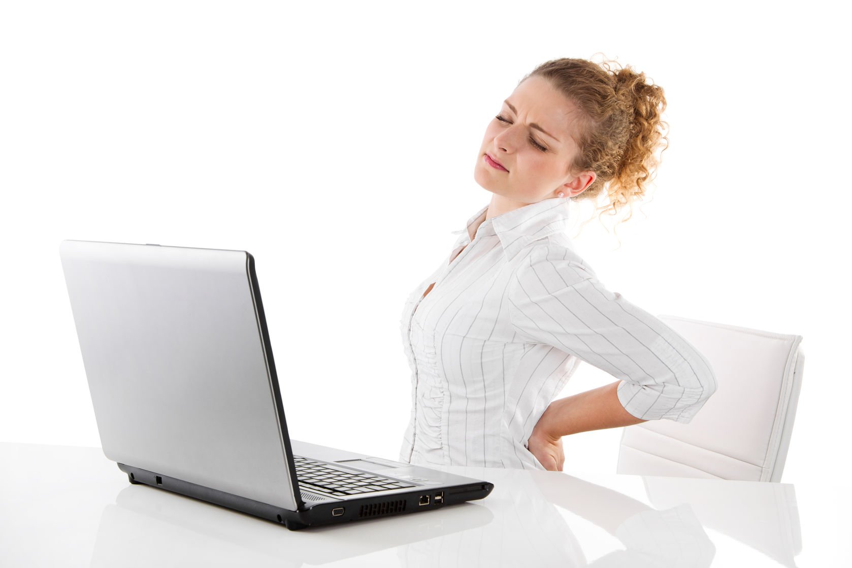 back pain - young woman in office with laptop