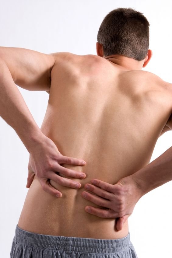 man holding his back inpain