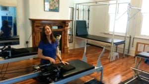 Jodie Krantz in the Free2move pilates studio giving instructions on how to use the equipment