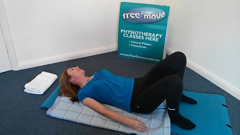 Jodie Krantz lying on a blanket with arms by her side and neck to one side in the Feldenkrais studio at Free2move