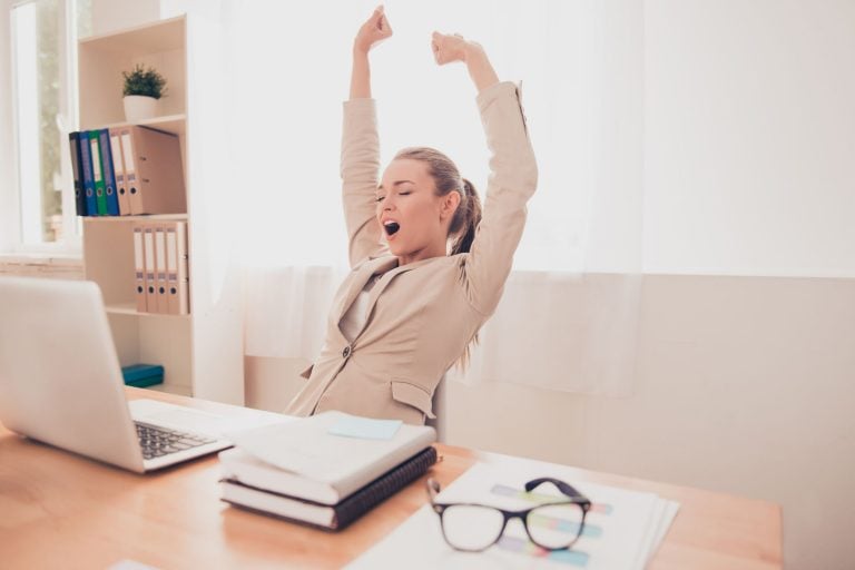 businesswoman stretching after prolonged sitting at her computer and doing breathing exercises